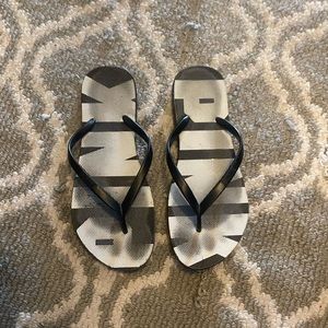 Well worn Pink Vs Flip Flops Beach Shoes